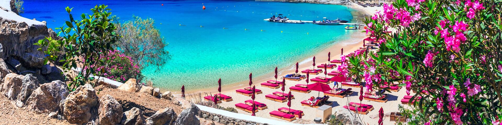 Panorama of Super Paradise Beach with Luxury Beach Club Umbrellas and Turquoise Aegean Sea in Mykonos Island Cyclades Greece