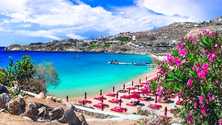 Panorama of Super Paradise Beach with Luxury Beach Club Umbrellas and Turquoise Aegean Sea in Mykonos Island Cyclades Greece