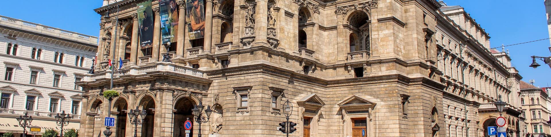 A historic building with ornate architecture, large arched windows, and a prominent entrance.