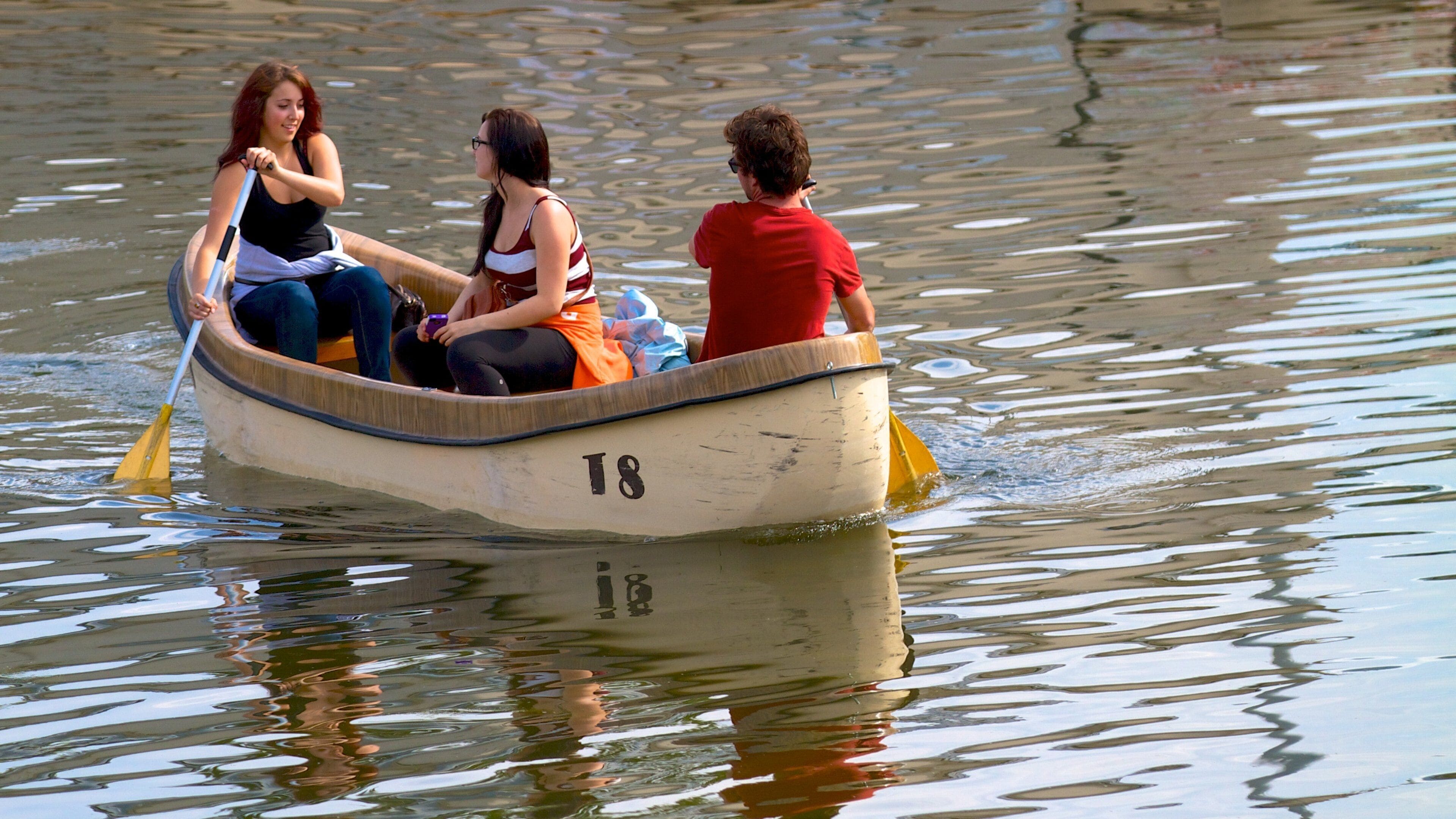 City Park showing a lake or waterhole and kayaking or canoeing as well as a small group of people