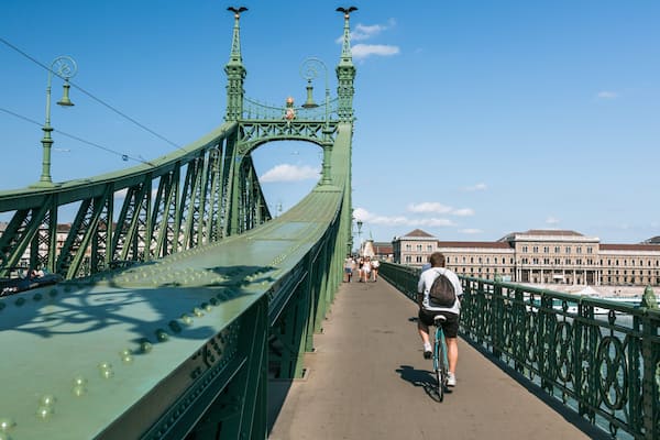 Liberty Bridge showing a bridge and cycling as well as an individual male