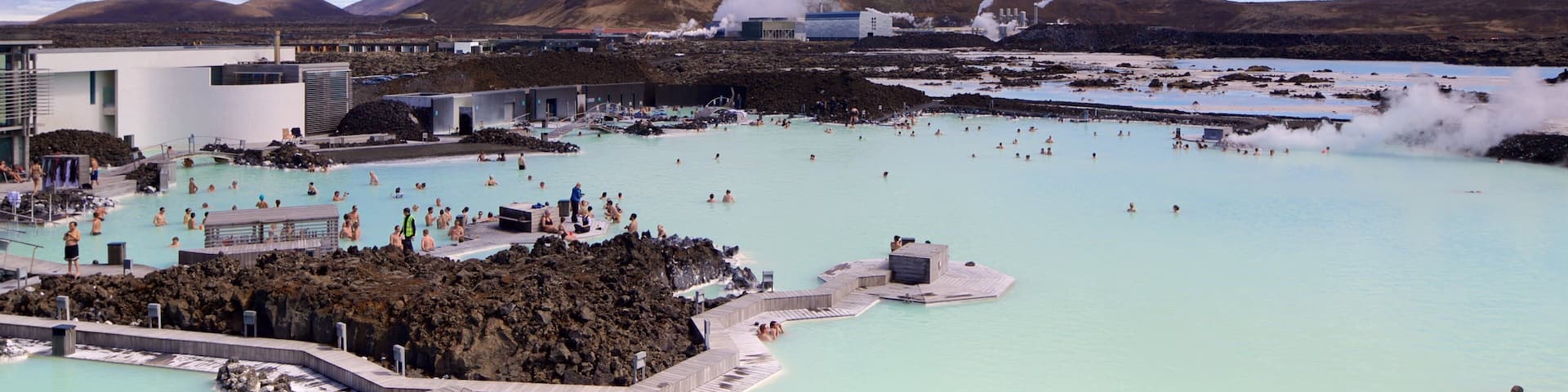 Blue Lagoon which includes a luxury hotel or resort and a hot spring as well as a large group of people