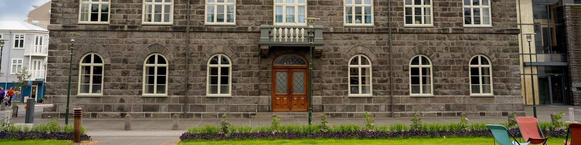 Reykjavík, Iceland - July 4, 2022 a horizontal view of the Althingi Parliament House, a classical 19th century structure which stands by Austurvöllur in central Reykjavík, Iceland.