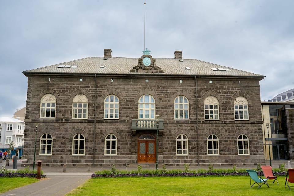 A historic stone building with arched windows and a central entrance.