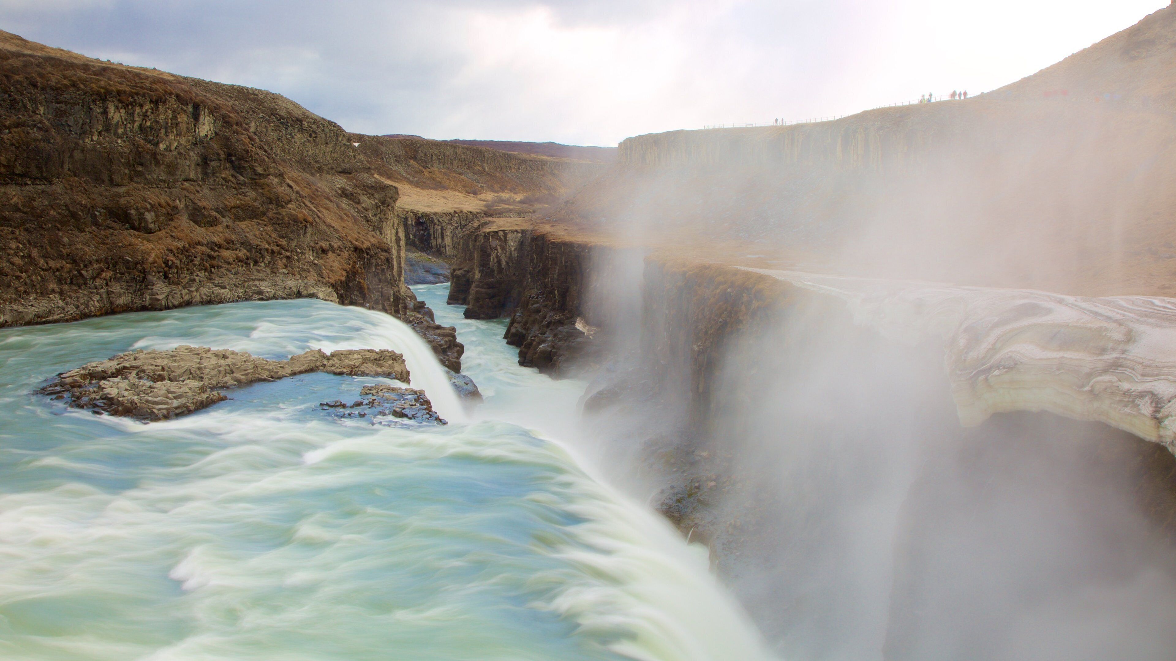 Gullfoss Waterfall featuring a gorge or canyon, mist or fog and a river or creek