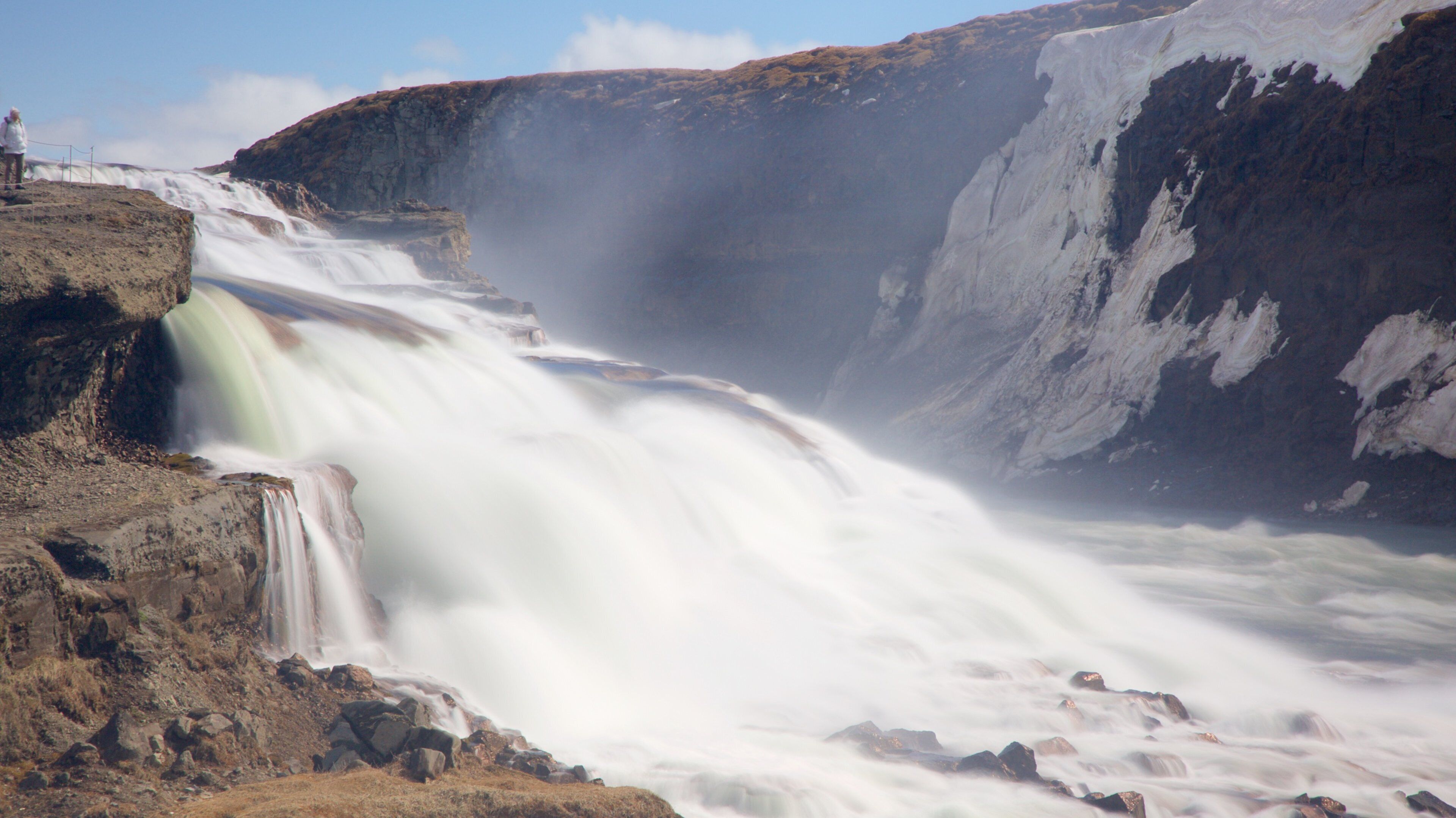 A powerful waterfall cascading down a rocky cliff.