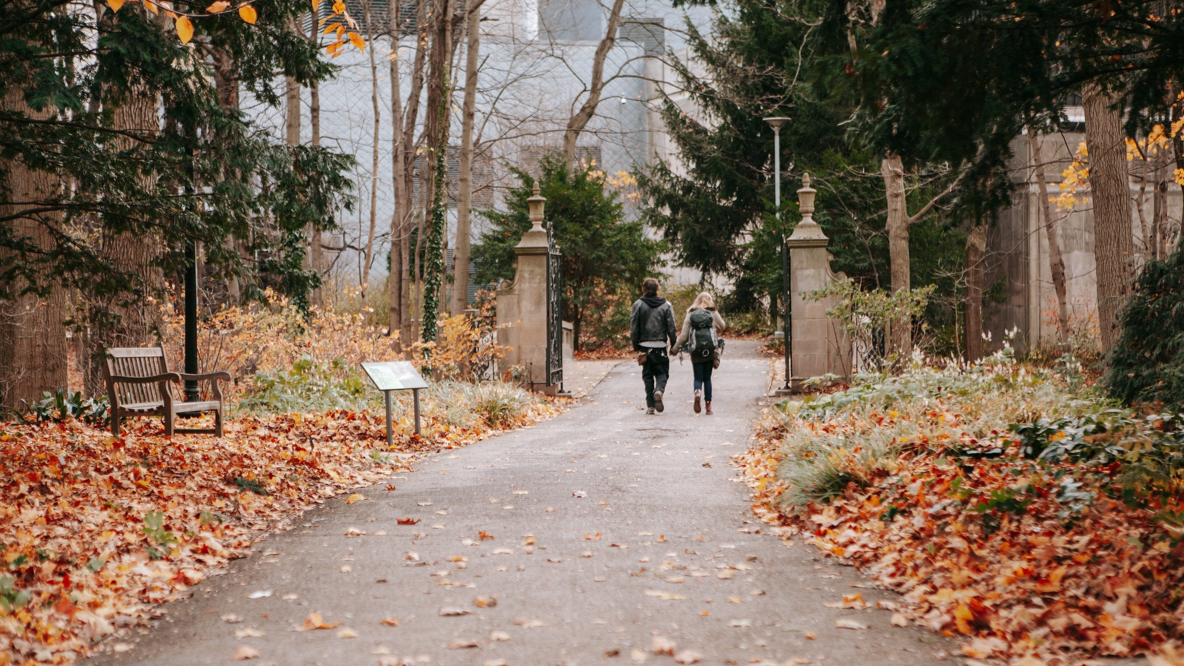 Indianapolis Museum of Art at Newfields featuring fall colors and a park as well as a couple