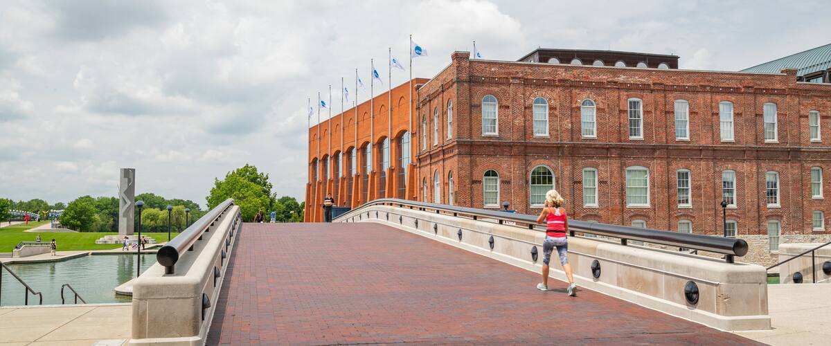 NCAA Hall of Champions showing street scenes and a bridge as well as an individual femail