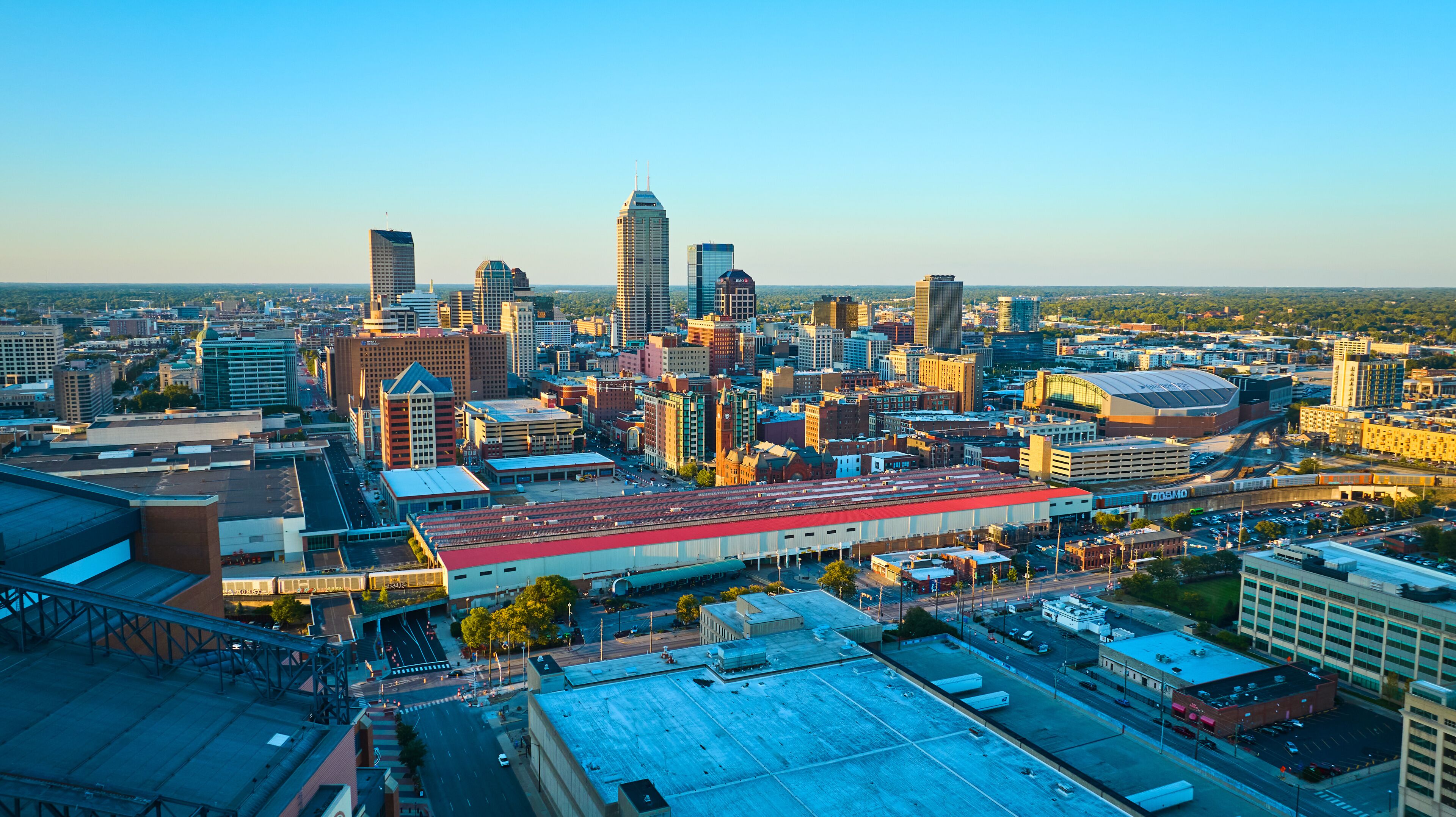 Aerial Golden Hour Cityscape with Stadium and Skyscrapers