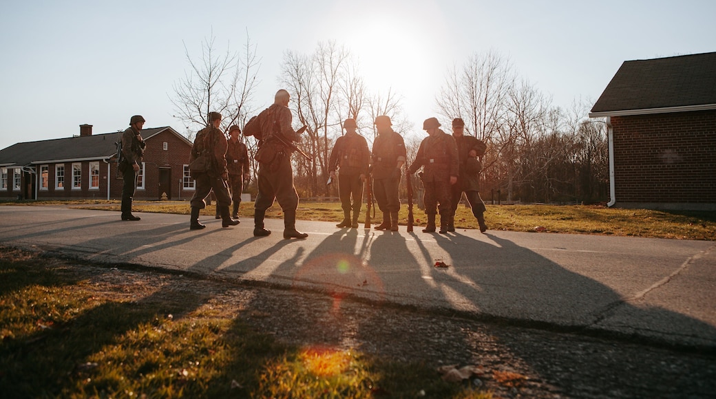 Fort Harrison State Park featuring military items and a sunset as well as a small group of people