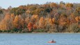 Eagle Creek Park which includes a river or creek, autumn leaves and kayaking or canoeing
