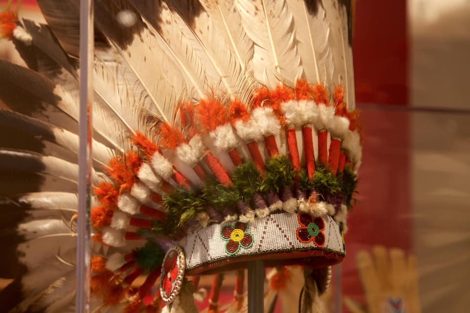 A Native American headdress with feathers and beadwork.