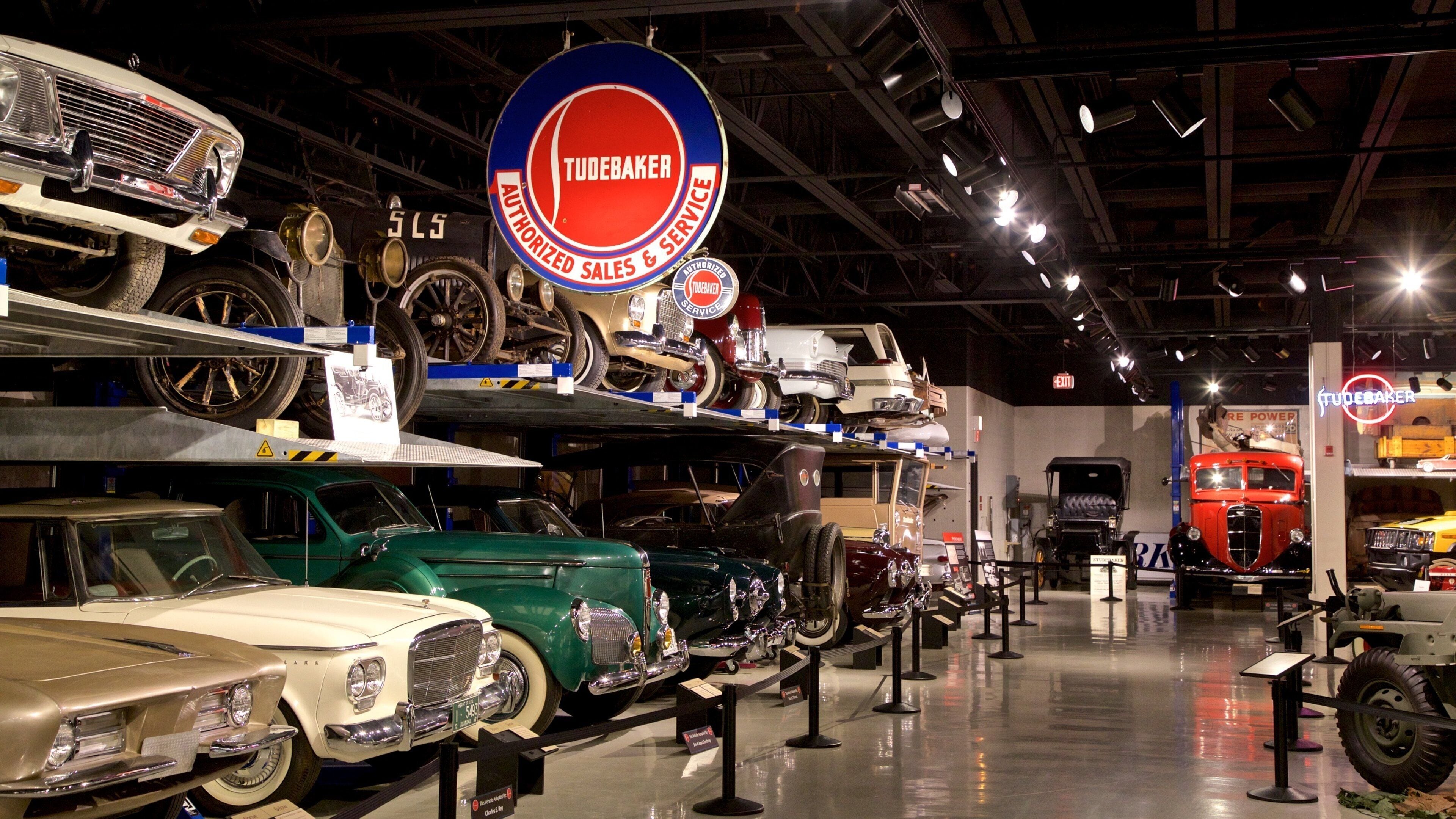 A vintage car exhibition with various classic cars on display.