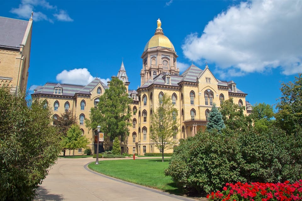A large historic building with a prominent golden dome and arched windows.