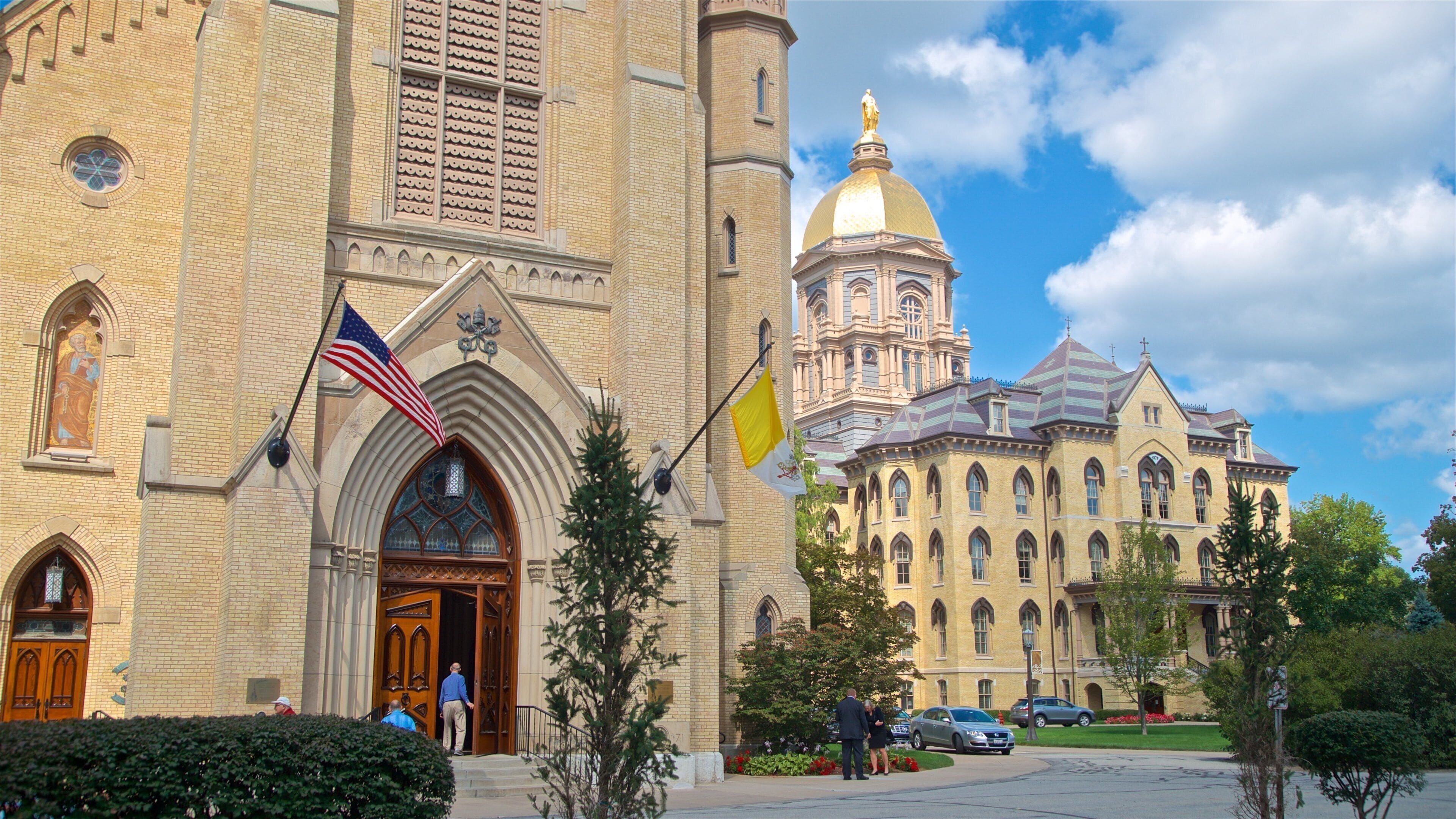A large brick building with a golden dome and arched windows.