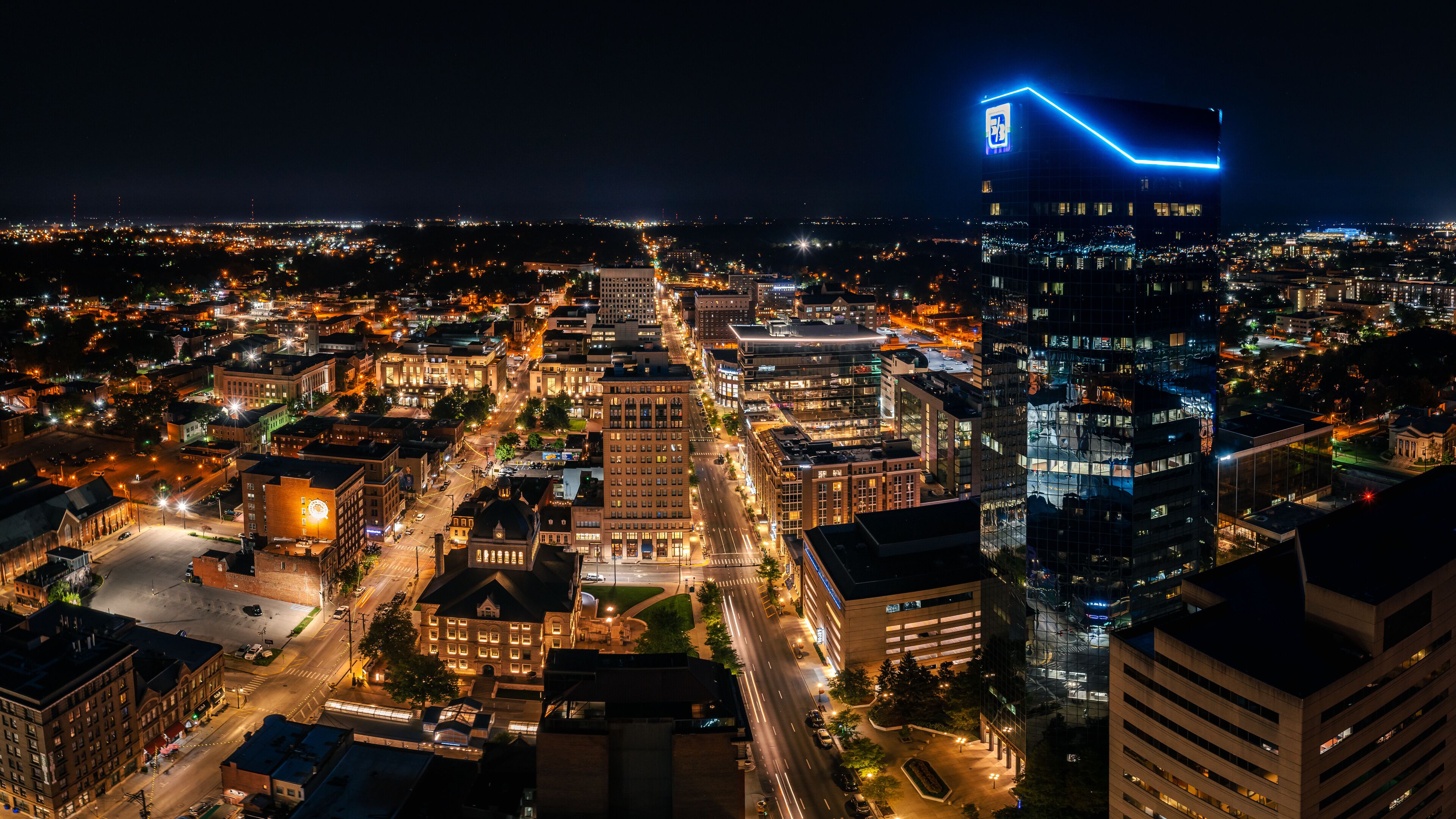 Aerial photograph of the Lexington, Kentucky skyline at night with the city alite.