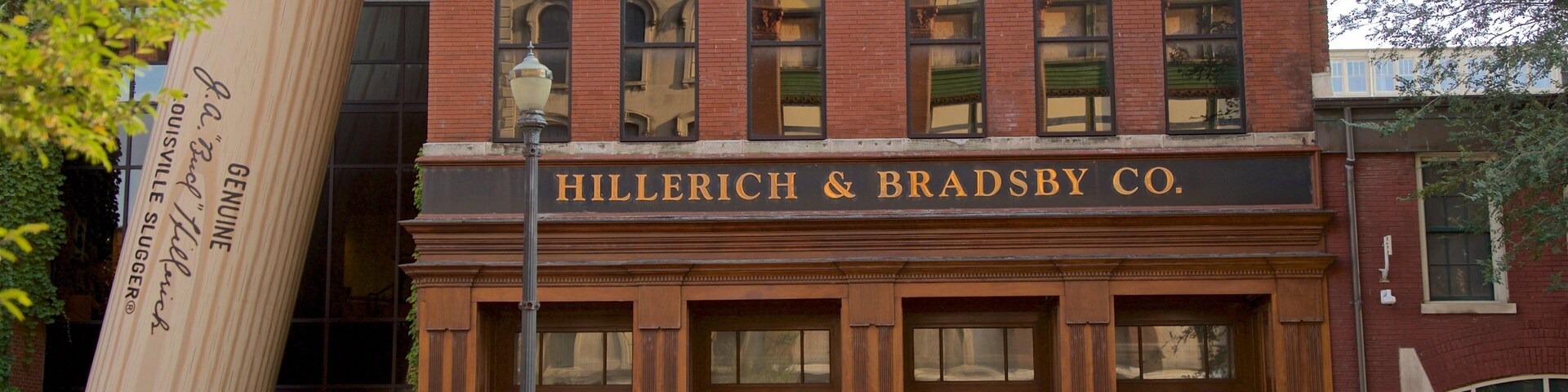 Louisville Slugger Museum which includes outdoor art and signage as well as a small group of people