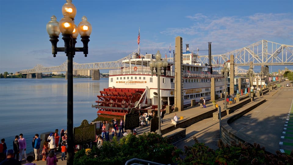 Belle of Louisville featuring a bay or harbor and a ferry as well as a small group of people