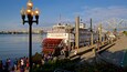 Belle of Louisville featuring a bay or harbor and a ferry as well as a small group of people