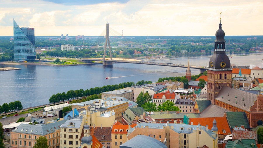 A cityscape with a river, a bridge, and historic buildings.