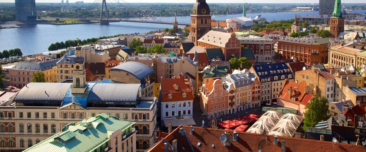 A cityscape with historic buildings, a river, and a modern bridge.