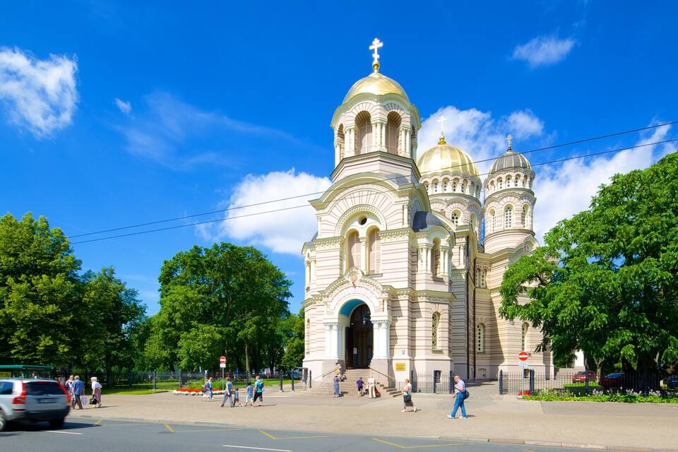 A large, ornate church with multiple domes and a golden cross on top.