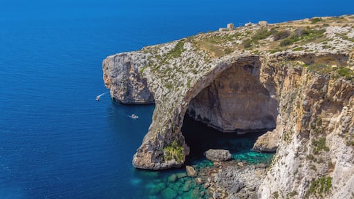 Blue Grotto rock cliff arch in Malta, aerial view from the Mediterranean Sea to the island.