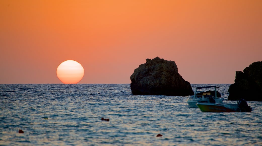 Golden Sands Beach featuring rocky coastline and a sunset