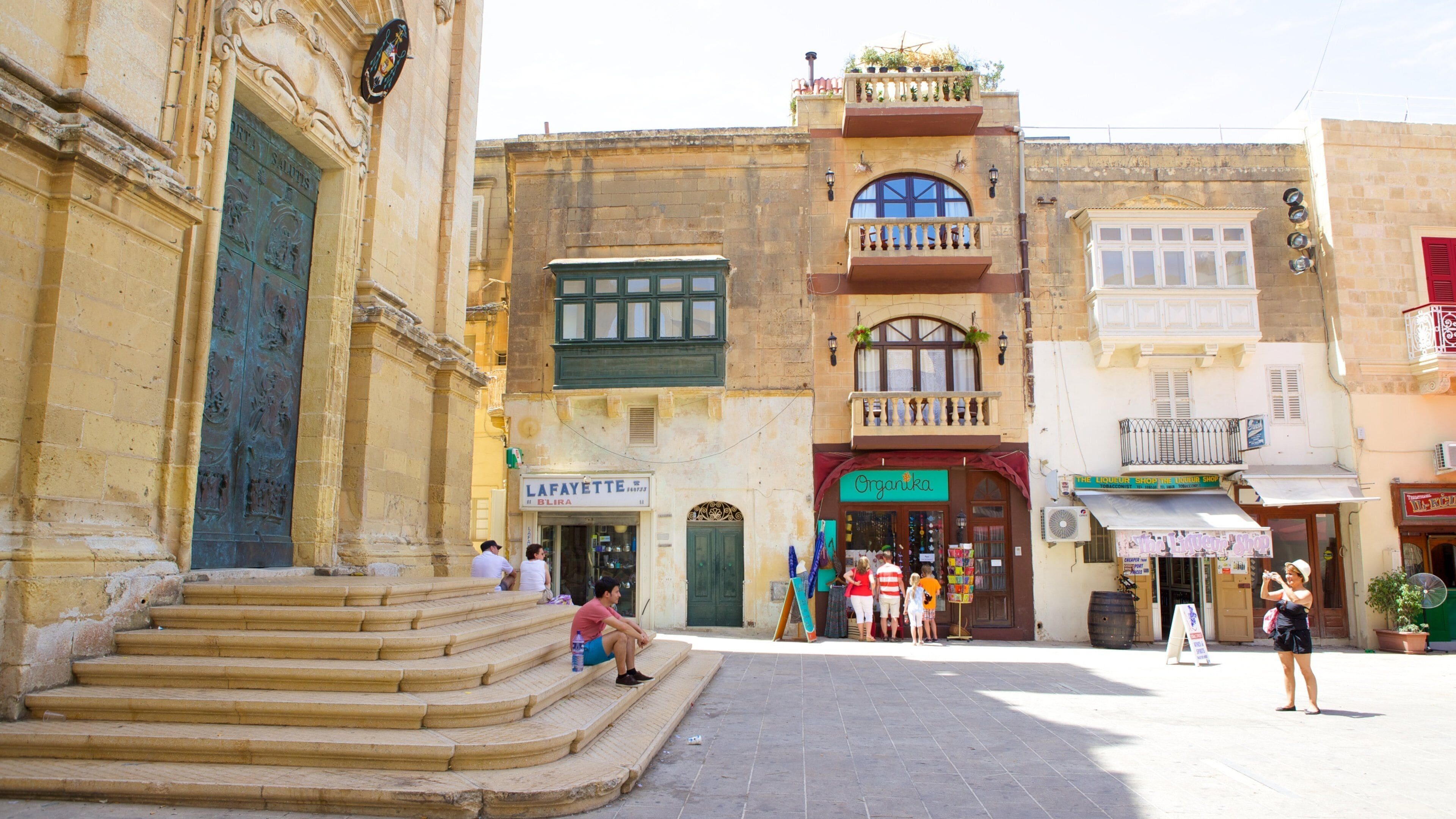 St. George\'s Basilica which includes heritage architecture, a small town or village and a square or plaza