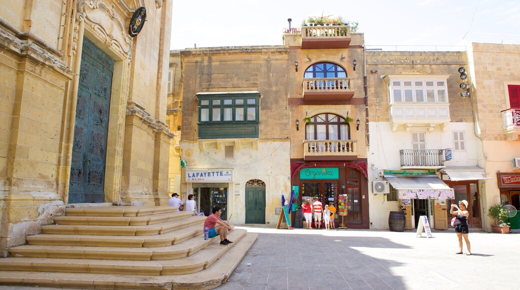 St. George\'s Basilica which includes a small town or village, heritage architecture and a square or plaza