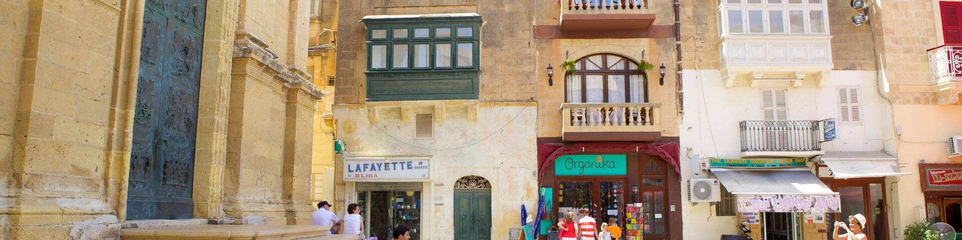 St. George\'s Basilica which includes a small town or village, heritage architecture and a square or plaza