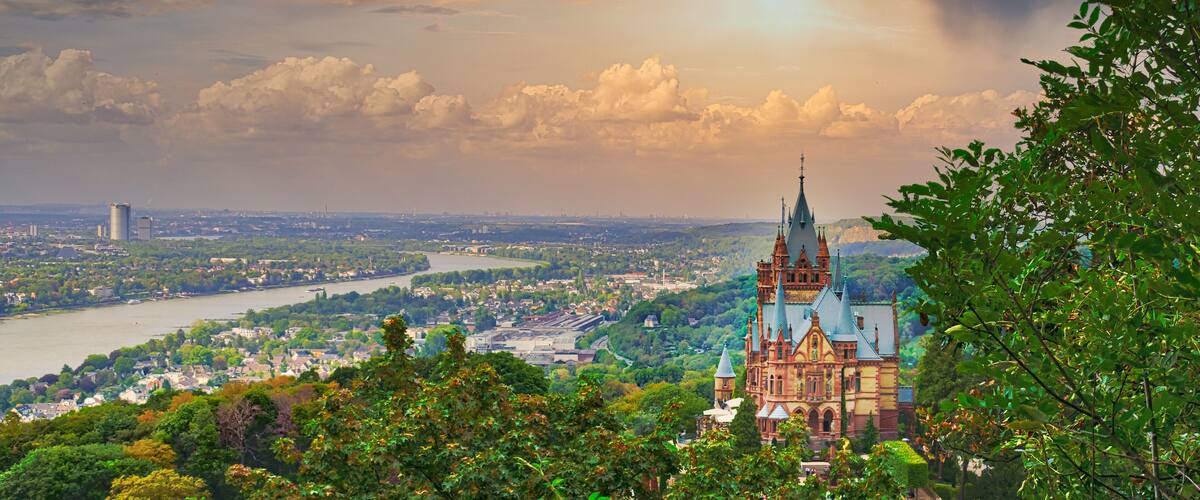 Beautiful cityscape with the castle of Drachenburg on a sunset sky background in Germany
