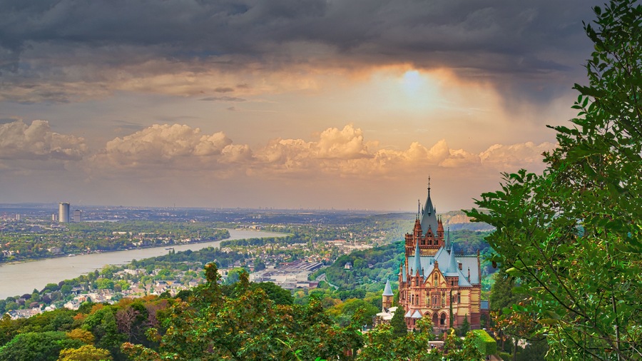 Beautiful cityscape with the castle of Drachenburg on a sunset sky background in Germany