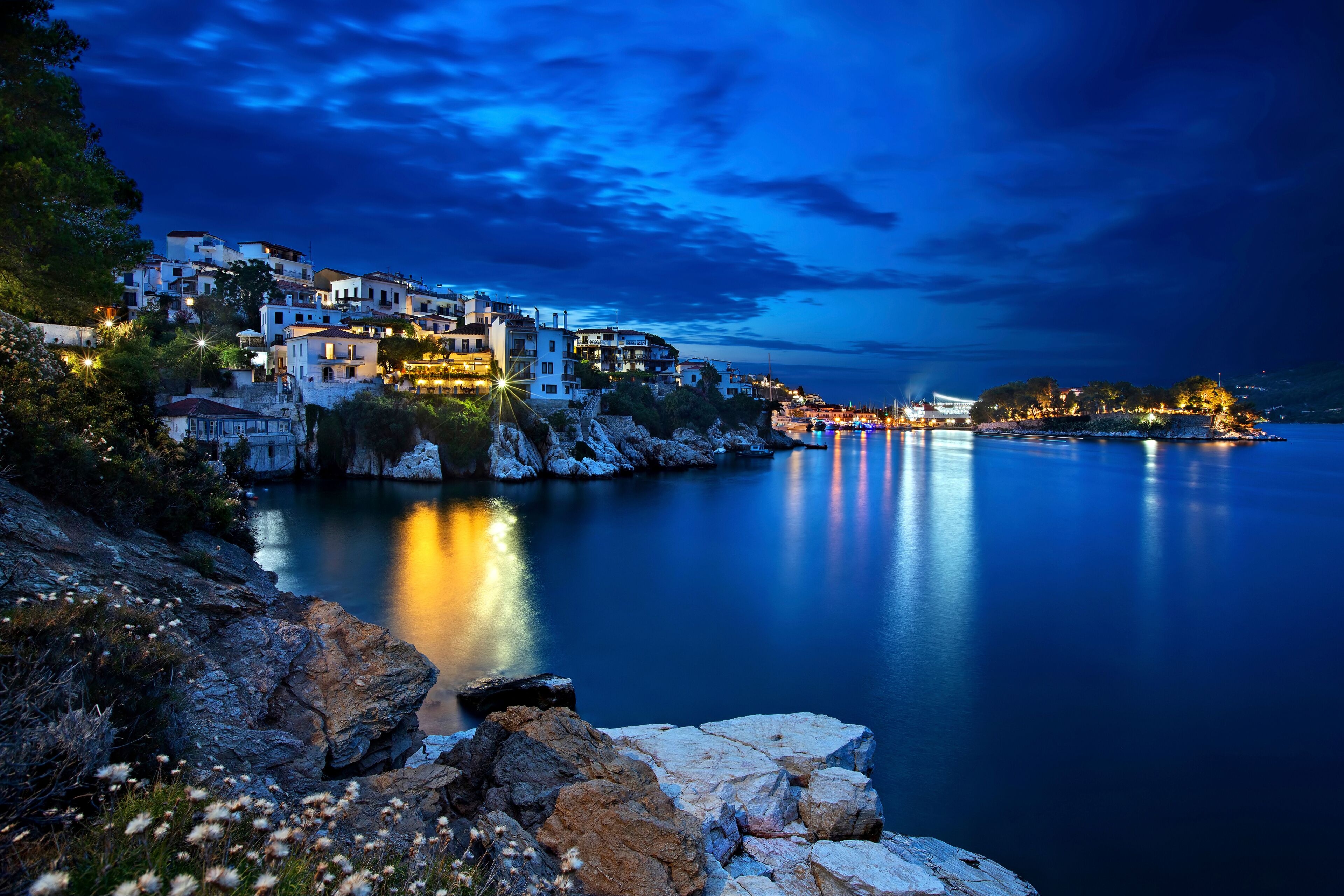 Night view of Plakes, the oldest neighborhood of Skiathos town. To the right, you can see Bourtzi castle.  Skiathos island, Northern Sporades, Greece.