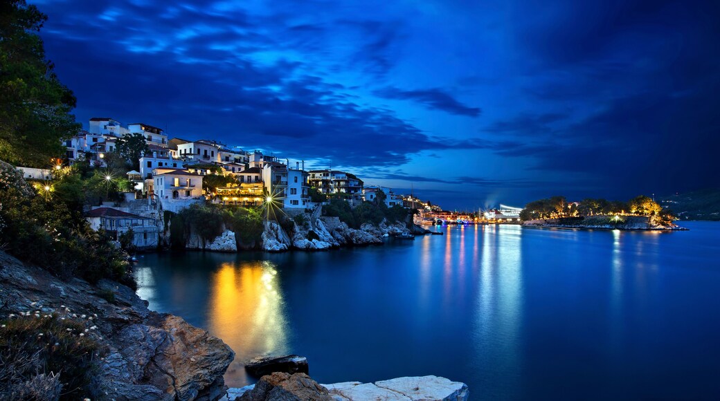 Night view of Plakes, the oldest neighborhood of Skiathos town. To the right, you can see Bourtzi castle. Skiathos island, Northern Sporades, Greece.