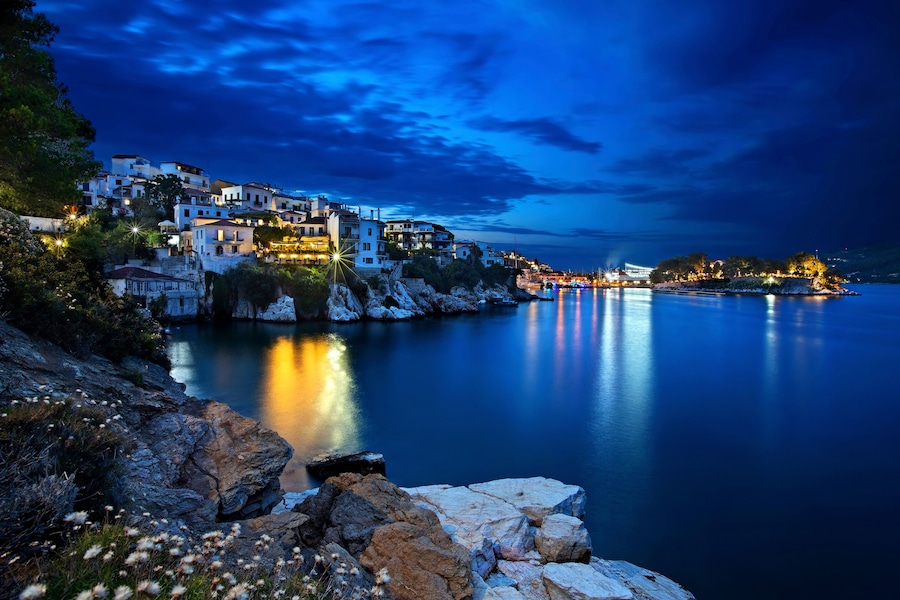 Night view of Plakes, the oldest neighborhood of Skiathos town. To the right, you can see Bourtzi castle. Skiathos island, Northern Sporades, Greece.