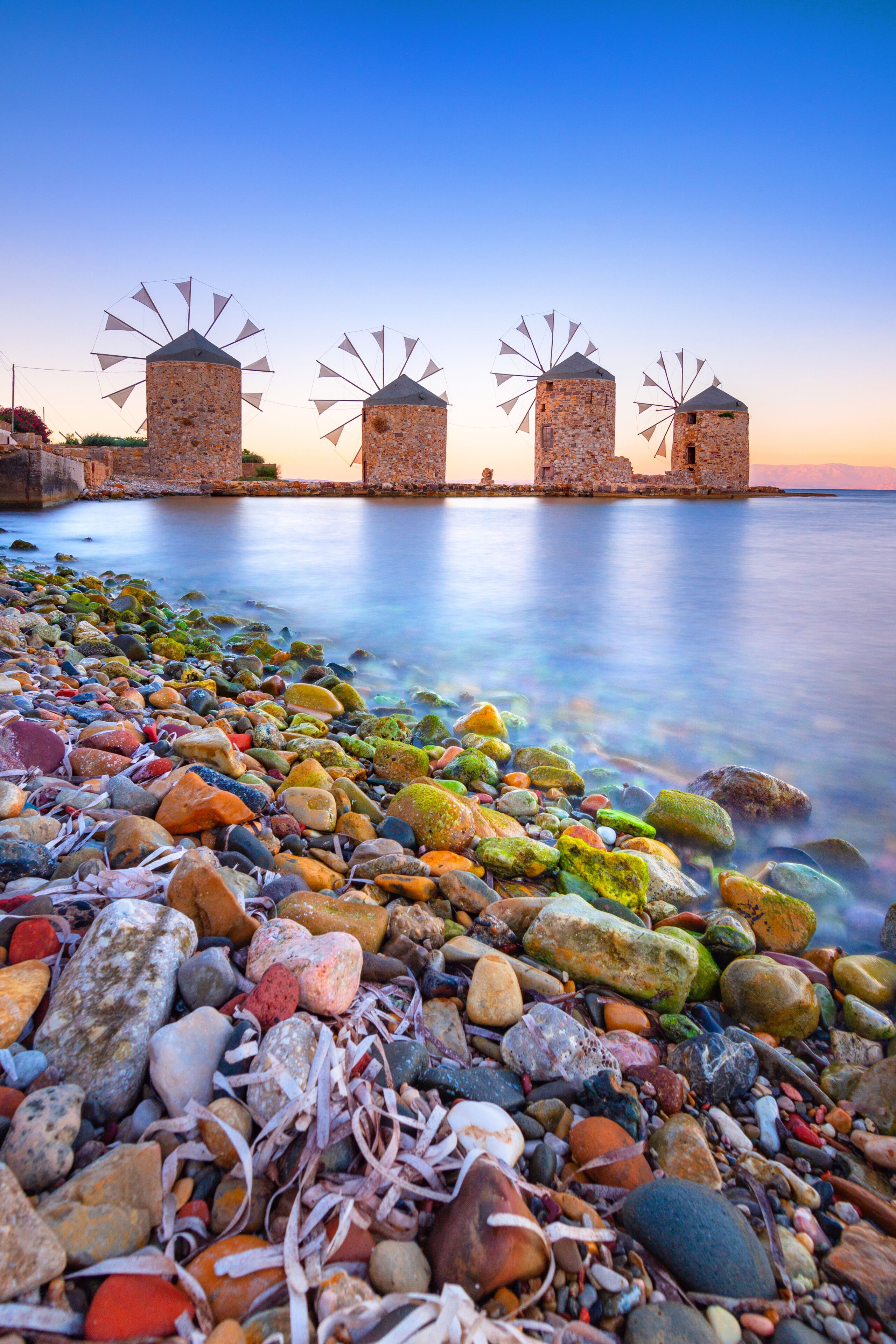 Old windmills by the beach, Chios island, Greece.