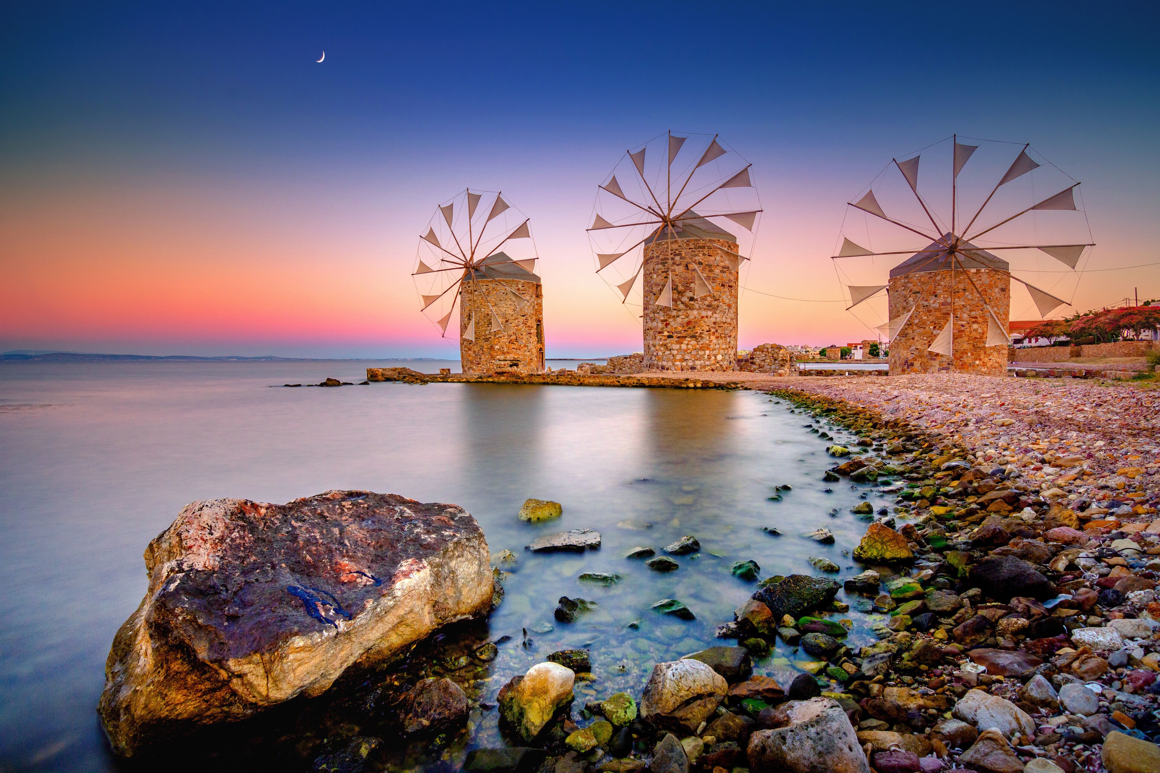Old windmills by the beach, Chios island, Greece.