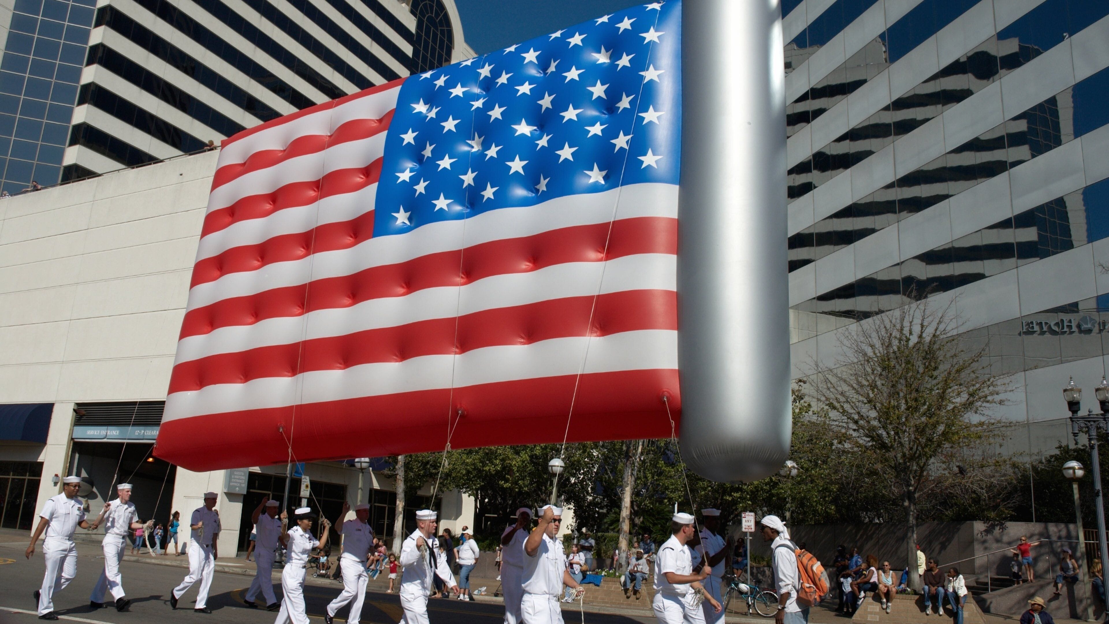 Downtown Jacksonville featuring a festival and military items as well as a large group of people
