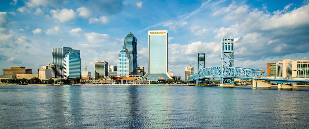 Downtown Jacksonville which includes skyline, a city and a river or creek