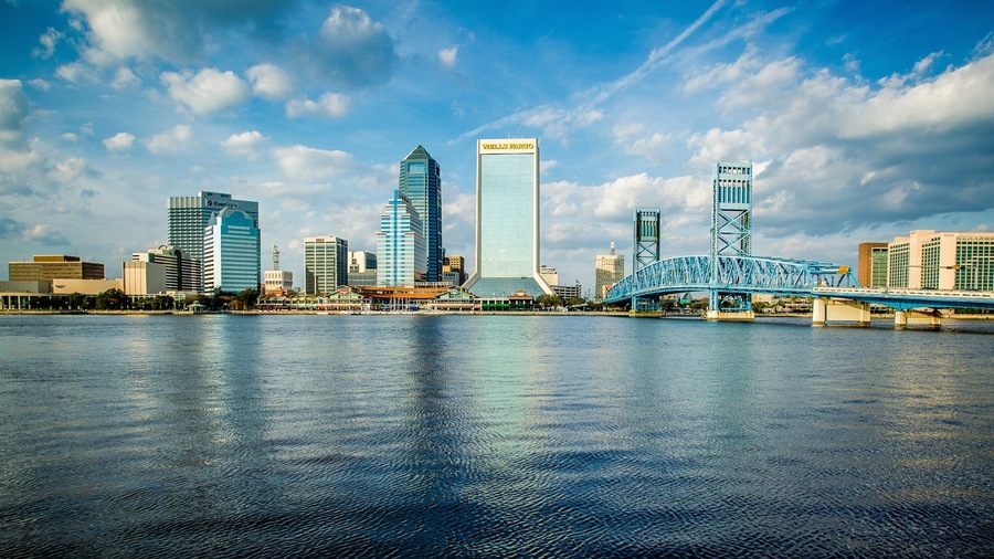 Downtown Jacksonville which includes skyline, a city and a river or creek