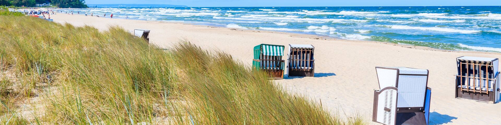 Traditional wicker chairs on sandy beach in Baabe town, Ruegen island, Baltic Sea, Germany