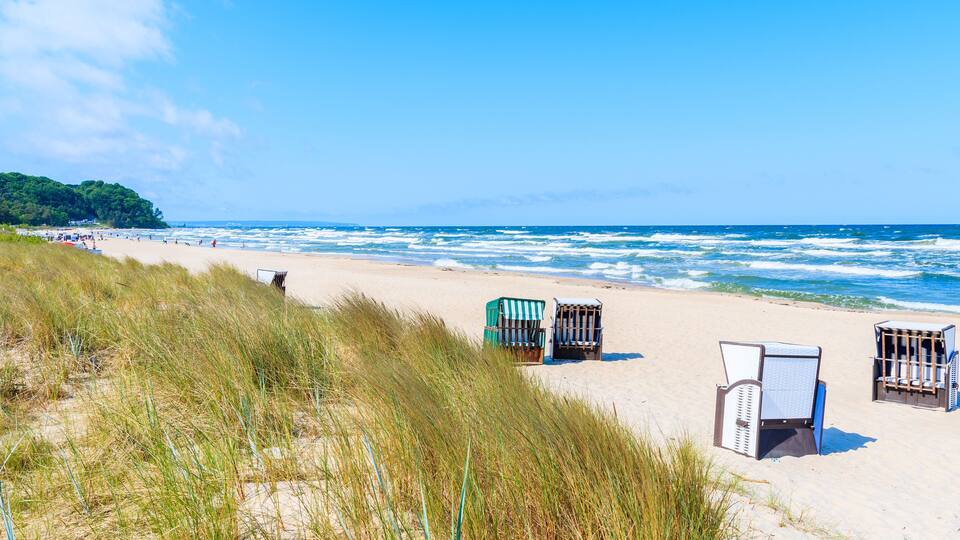 Traditional wicker chairs on sandy beach in Baabe town, Ruegen island, Baltic Sea, Germany