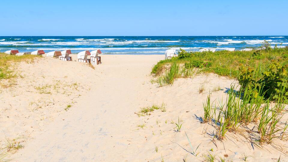 Traditional wicker chairs on sandy beach in Baabe town, Ruegen island, Baltic Sea, Germany