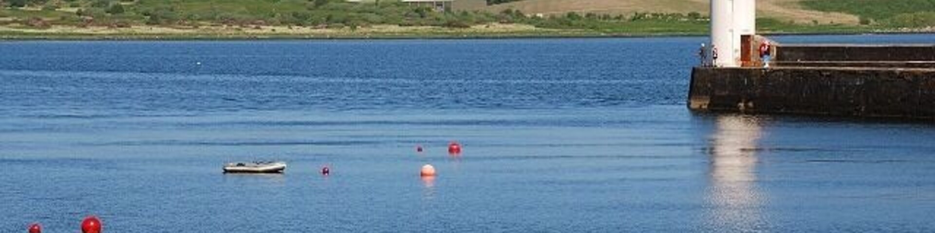 Ardrishaig pier and light It's a beautiful sunny afternoon with a good breeze, so all the mooring buoys are empty - everyone's out enjoying the sailing. Lingerton landfill on the other side of Loch Gilp.