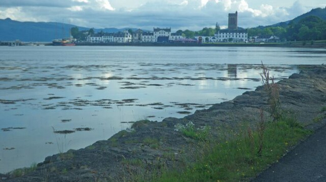 Shoreline and tideland along the A83 Road, near to Ardrishaig, Argyll And Bute, Great Britain. This is an evening view looking south along the shoreline with the town of Ardrishaig in the distance.