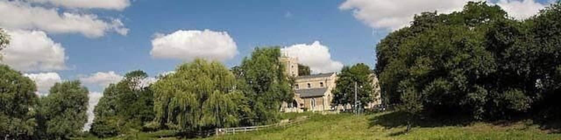 Holywell Church View of the church taken from the flood plain, looking across the brook that runs in "front" of Holywell into the river Great Ouse.