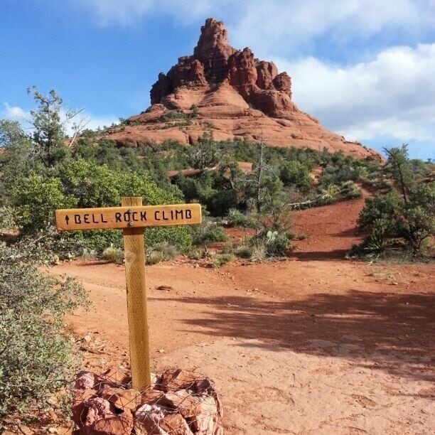 A rocky terrain with a sign indicating 'Bell Rock Climb'.