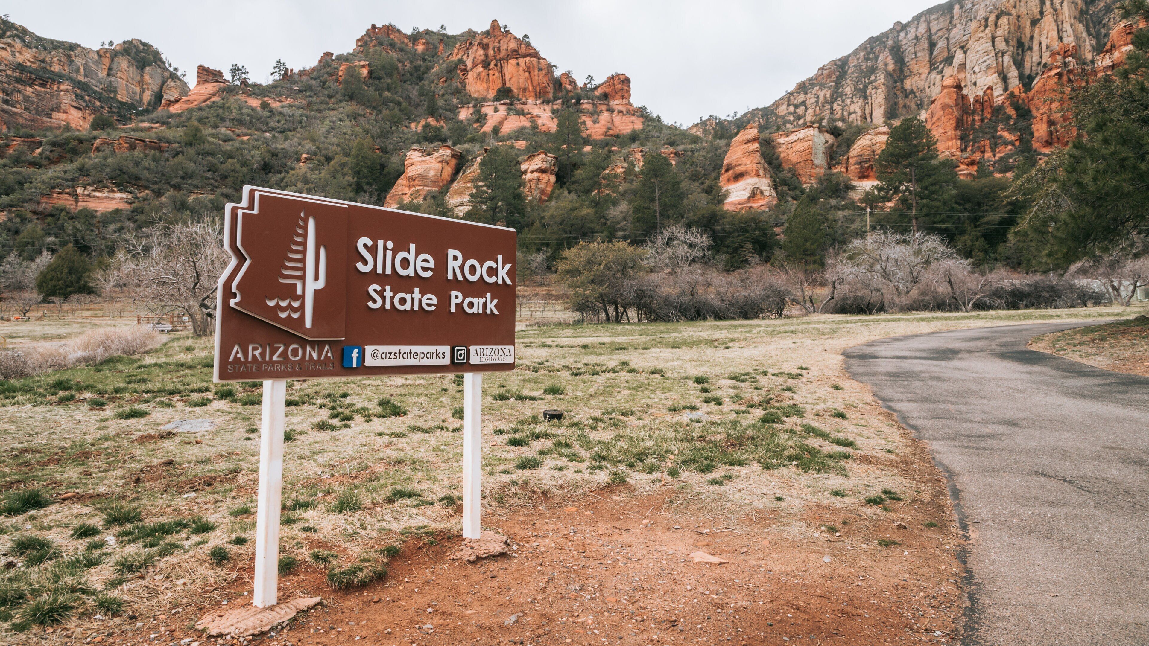 Slide Rock State Park which includes signage and a gorge or canyon
