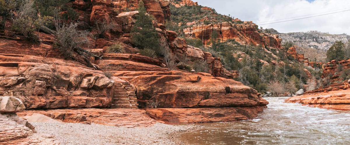 Slide Rock State Park featuring a river or creek and a gorge or canyon